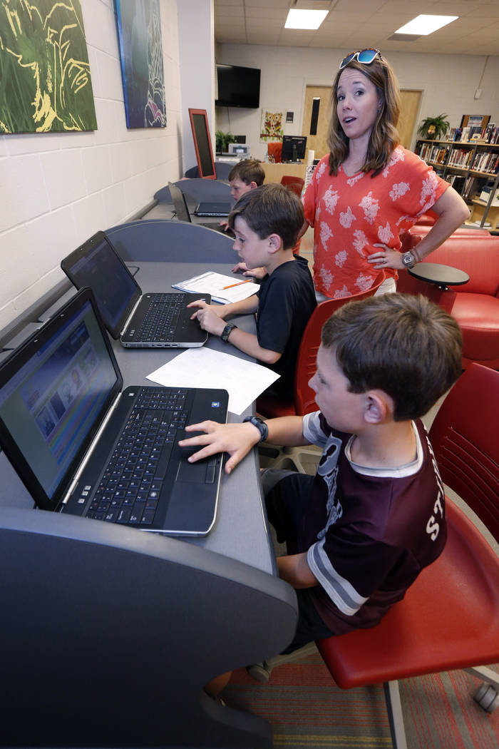 In this May 8, 2019, photograph, Sharon Stidham, standing, talks to her sons Graham, center, an ...