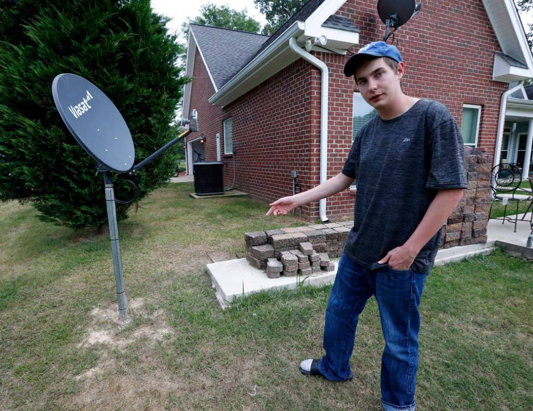 In this May 8, 2019, photo, Riley Shaw talks about his family's internet at his home outside St ...