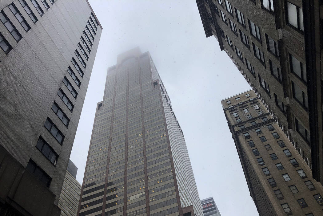 Mist and smoke cover the top of a building near 51st Street and 7th Avenue Monday, June 10, 201 ...