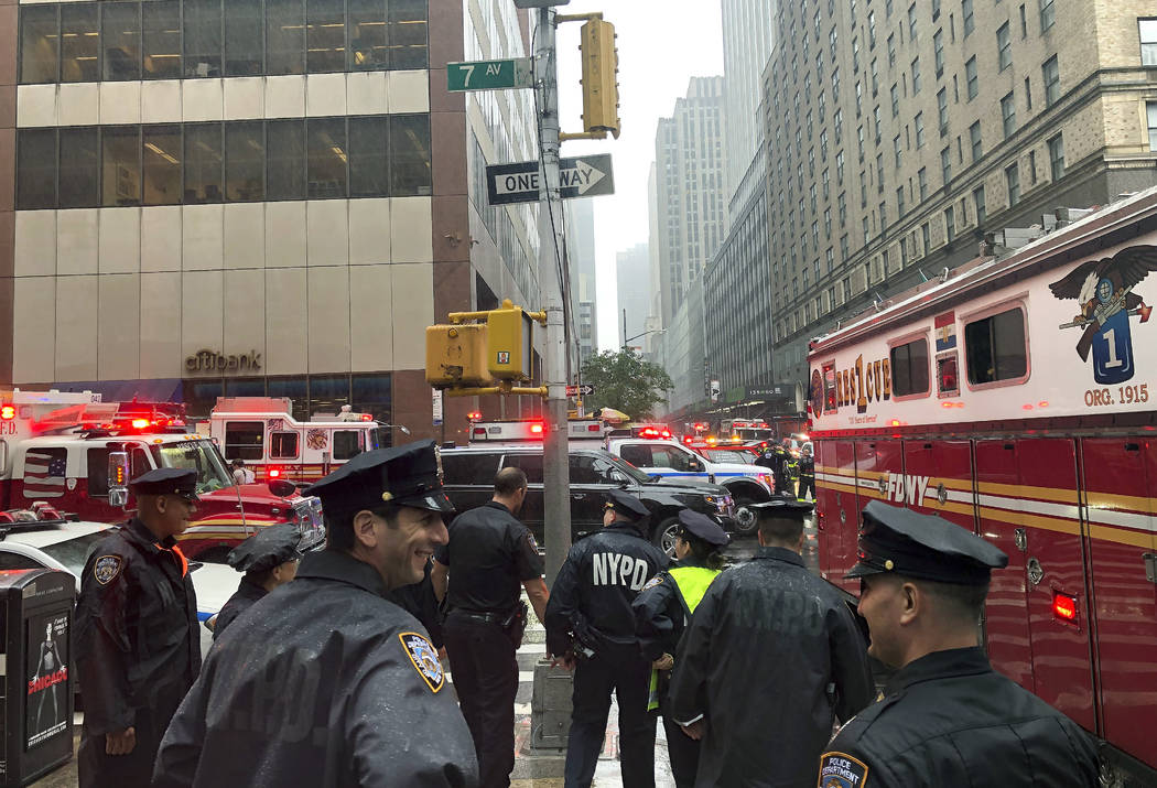 New York police officers monitor the streets near 51st Street and 7th Avenue, Monday, June 10, ...