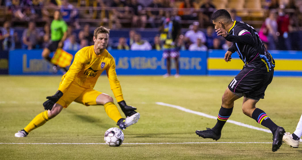 Las Vegas Lights FC forward Irvin Parra (11, right) sends a shot towards the net past Orange Co ...