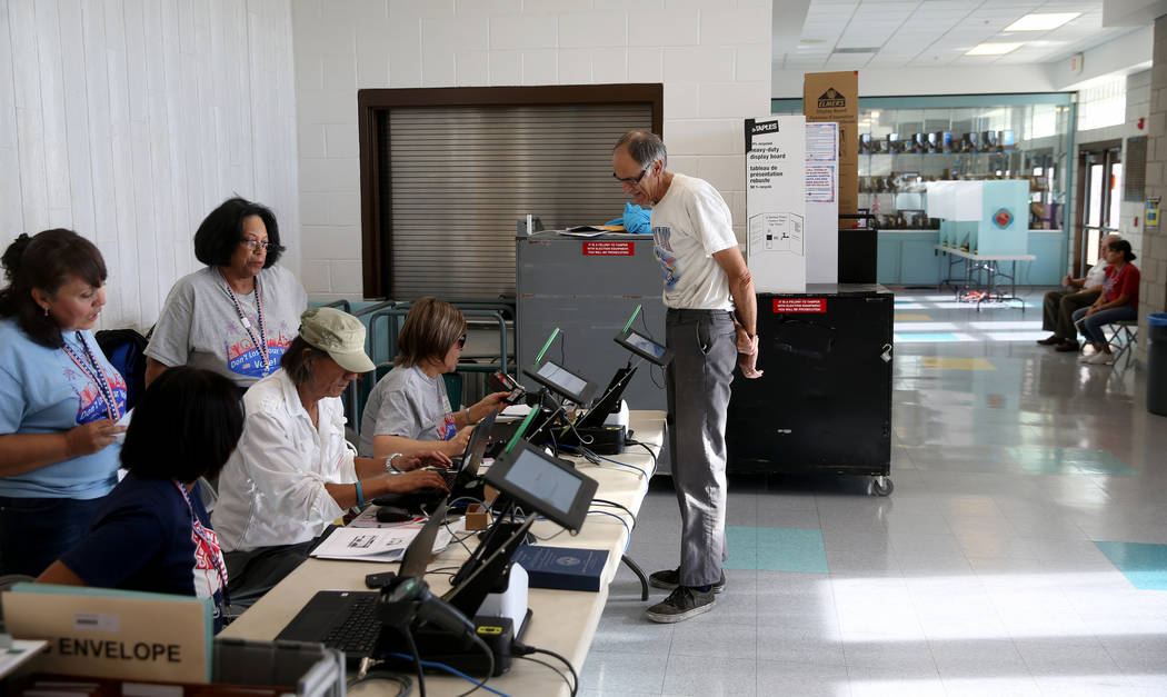 Kim Een of Las Vegas checks in to vote in the municipal election at Bonanza High School in Las ...