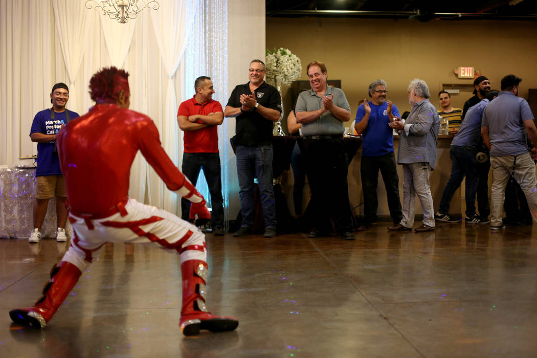 Jimmy Gonzales, a mannequin dancer, performs at an election night viewing party for former Asse ...