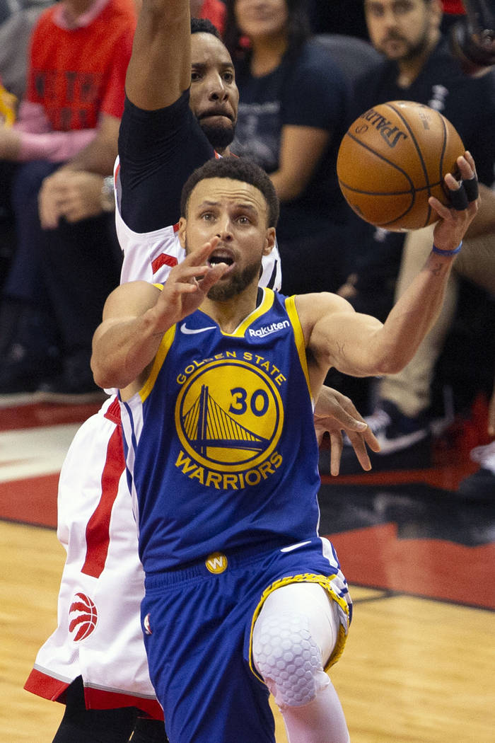 Golden State Warriors guard Stephen Curry (30) shoots over Toronto Raptors forward Norman Powel ...