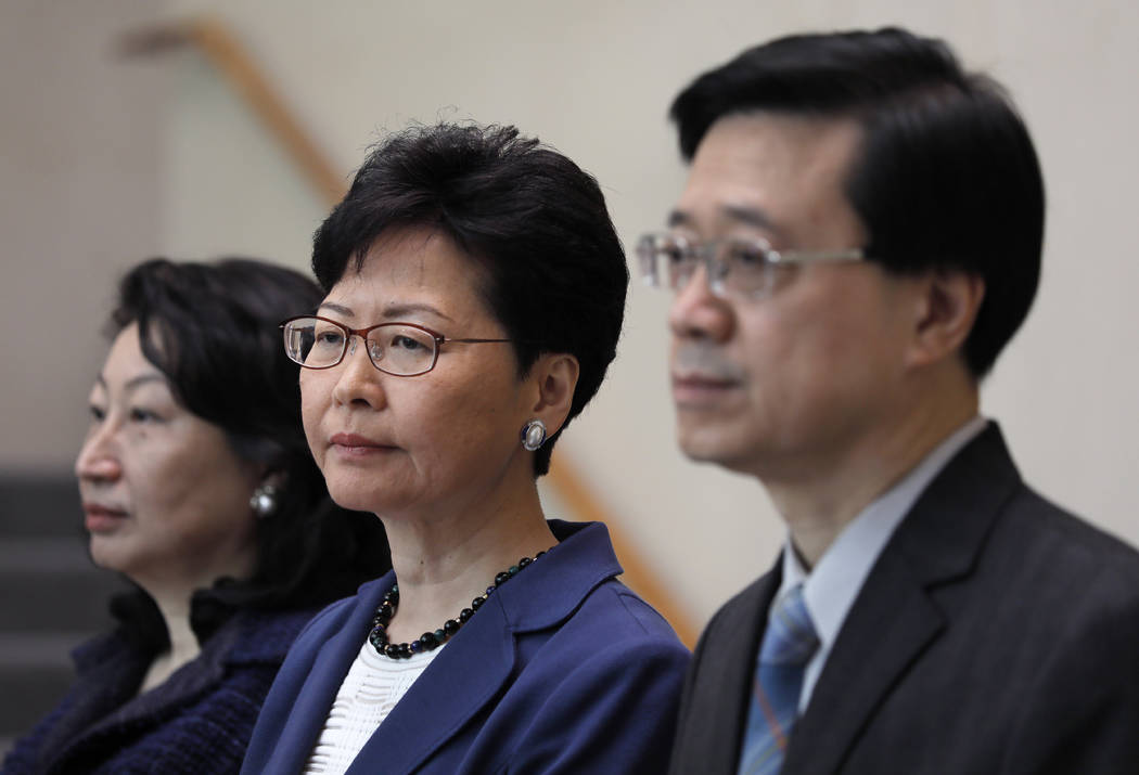 Hong Kong Secretary for Security John Lee, right, Hong Kong Chief Executive Carrie Lam, center ...