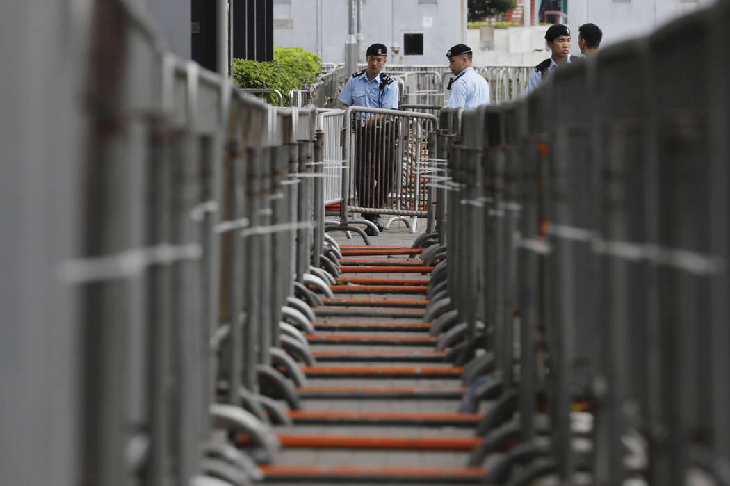 Police officers stand guard in front of barriers at the Legislative Council to prevent for stor ...