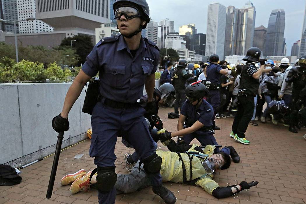 In this Monday, Dec. 1, 2014, file photo, a protester is arrested by police officers outside go ...