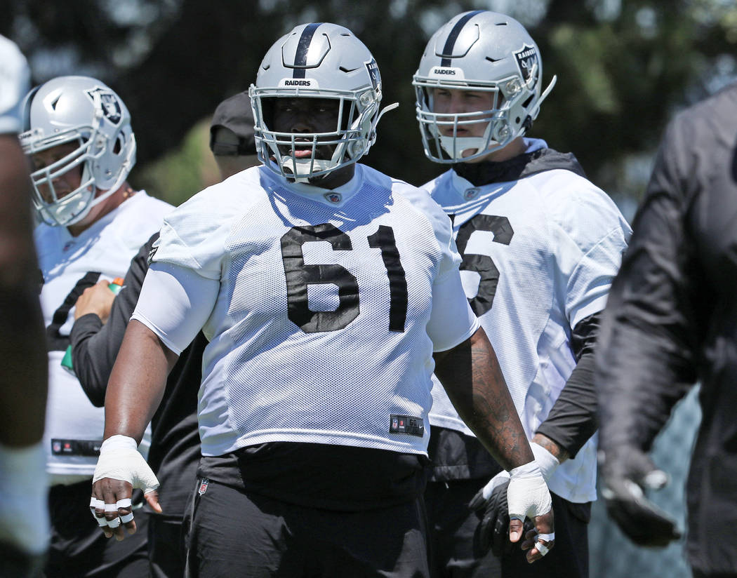 Oakland Raiders center Rodney Hudson (61) warms up during a mandatory mini-camp workout at the ...