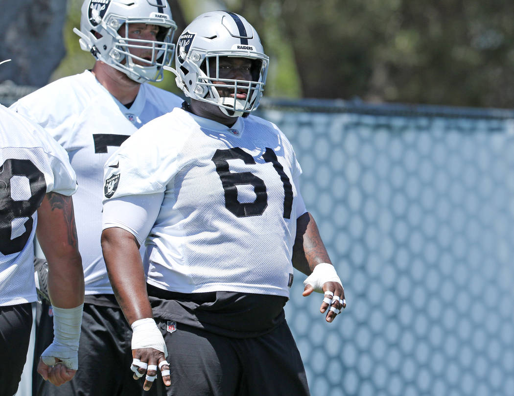 Oakland Raiders center Rodney Hudson (61) warms up during a mandatory mini-camp workout at the ...