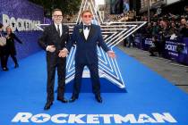 In this May 20, 2019, file photo, musician Elton John and his husband producer David Furnish, l ...