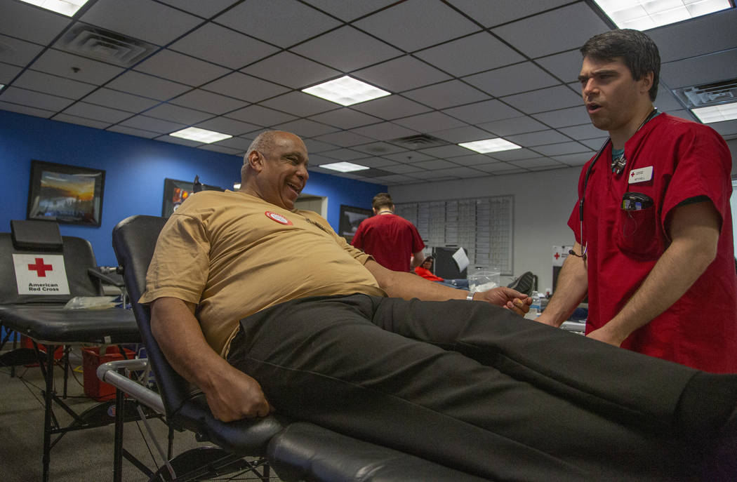 Mitchell Christensen, 28, from St. George, Utah, helps James Clark, 63, from St. Louis, left, ...