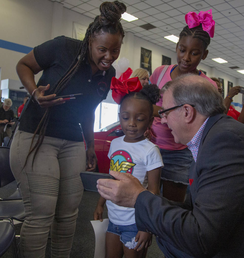 Gina Glass, 35, left, Gia Adams, 4, center, Jade Riddle, 11, back right, watch a video of Danie ...