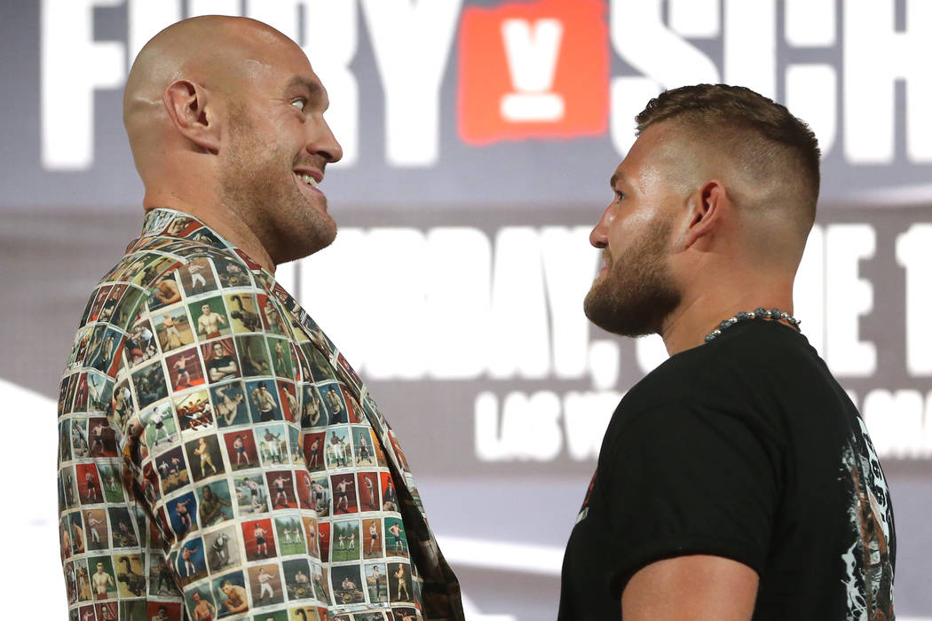 Tyson Fury, left, and Tom Schwarz, pose during their boxing press conference at the MGM Grand h ...