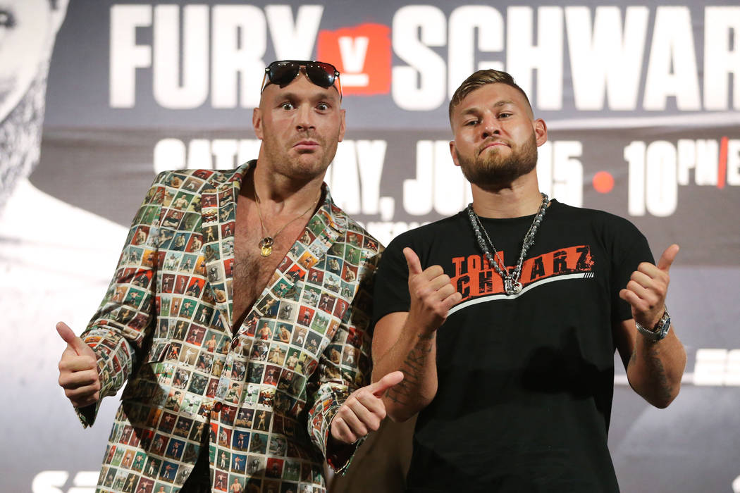 Tyson Fury, left, and Tom Schwarz pose during their boxing press conference at the MGM Grand ho ...