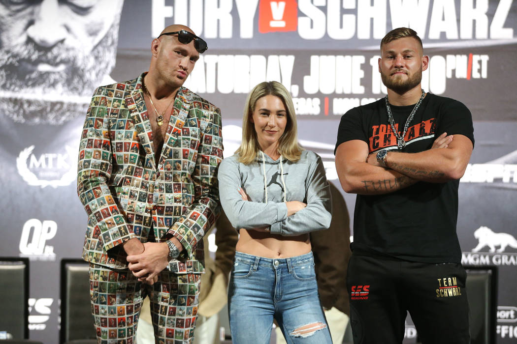 Boxers from left, Tyson Fury, Mikaela Mayer, and Tom Schwarz, pose during a boxing press confer ...