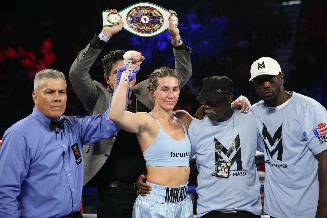 Mikaela Mayer, center, celebrates her win against Lizbeth Crespo in the womenÕs super feat ...