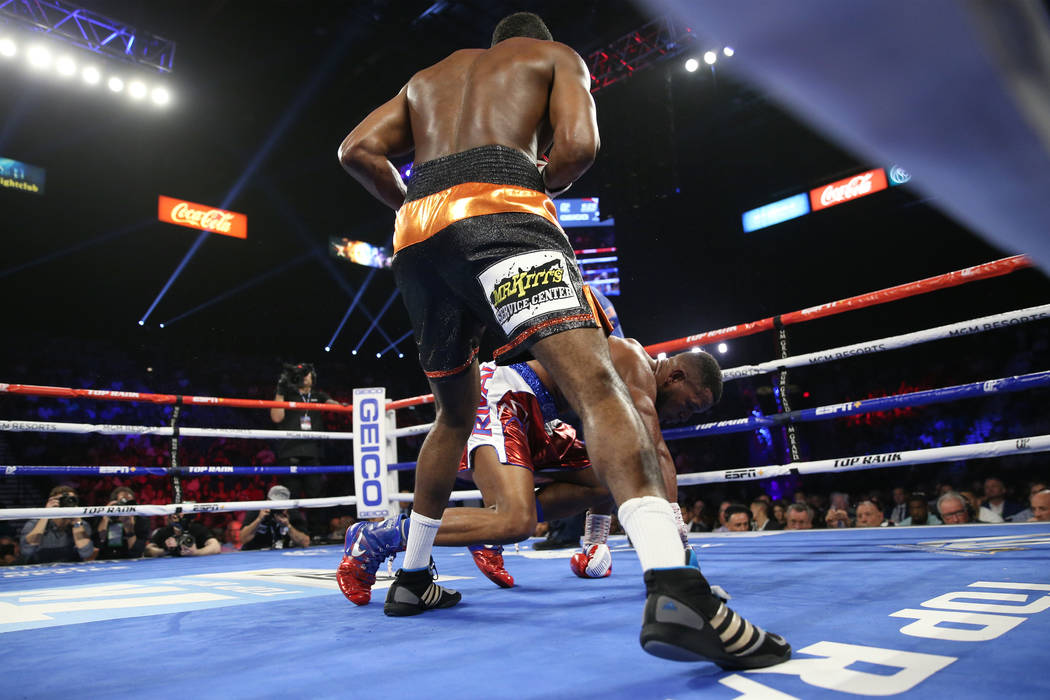 Jesse Hart, left, knocks down Sullivan Barrera in the light heavyweight bout at the MGM Grand G ...