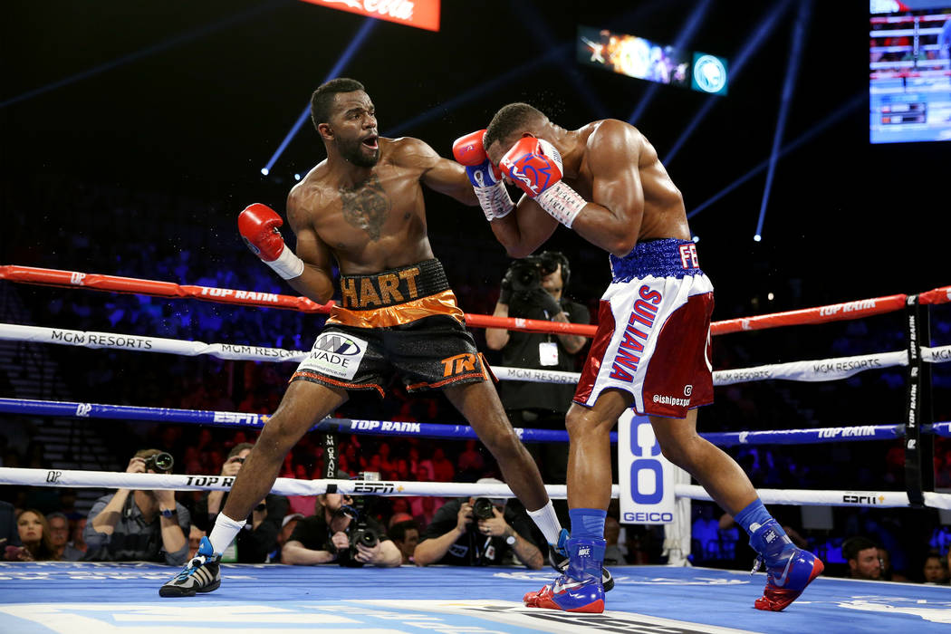 Jesse Hart, right, battles Sullivan Barrera in the light heavyweight bout at the MGM Grand Gard ...