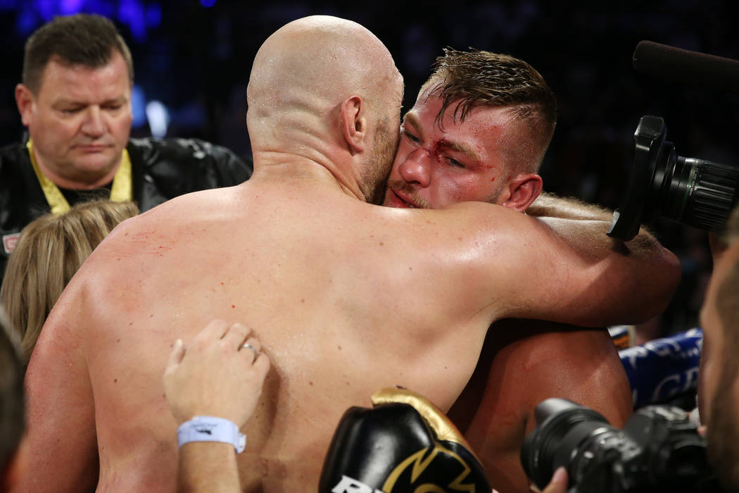 Tyson Fury, left, embraces Tom Schwarz after the lineal heavyweight bout at the MGM Grand Garde ...