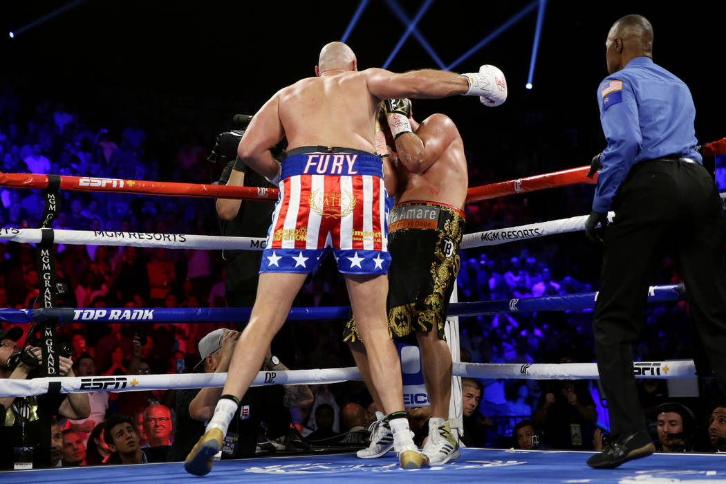 Tyson Fury, left, throws a punch against Tom Schwarz in the second round of the lineal heavywei ...