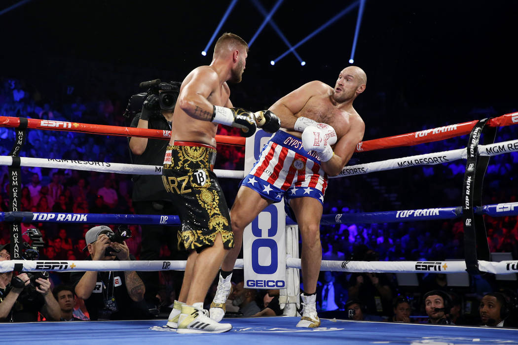 Tom Schwarz, left, battles Tyson Fury in the second round of the lineal heavyweight bout at the ...