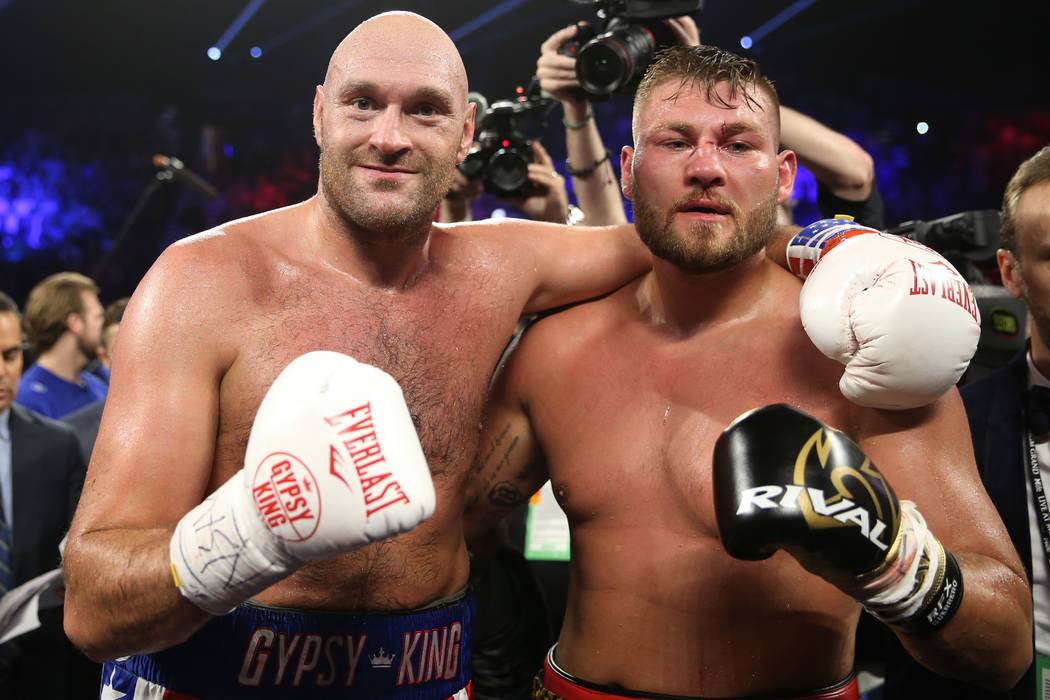 Tyson Fury, left, and Tom Schwarz pose after their fight in the lineal heavyweight bout at the ...