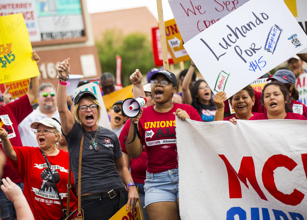 Darla Garcia, left, cheers in support of higher minimum wage outside of McDonald's in Las Vegas ...