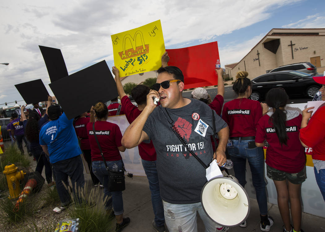 Jose Macias speaks while protesting in support of higher minimum wage outside of McDonald's in ...