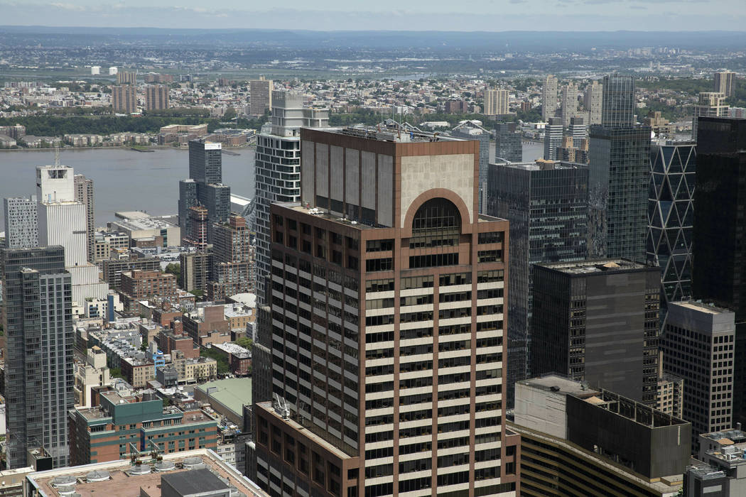 Law enforcement personnel work on the roof of the AXA Equitable building, center, Tuesday, June ...