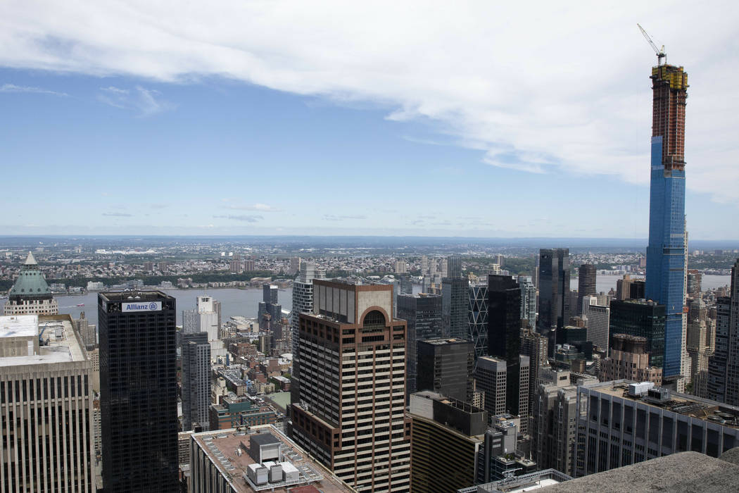 Law enforcement personnel work on the roof of the AXA Equitable building, center, Tuesday, June ...