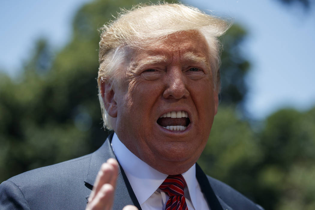 President Donald Trump speaks to reporters before departing for a trip to Iowa, on the South La ...