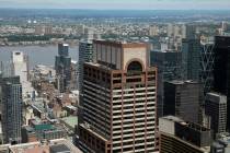 Law enforcement personnel work on the roof of the AXA Equitable building, center, Tuesday, June ...