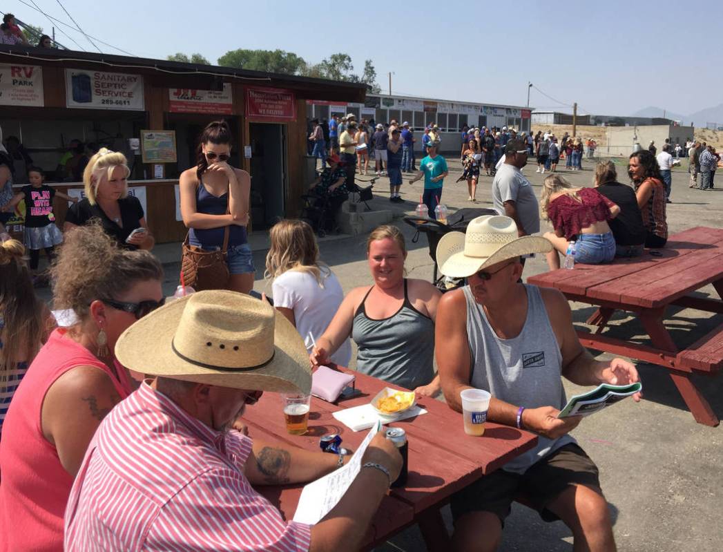 Fans handicap the next race at the White Pine Races on Sunday, August 19, 2018 in Ely. (Mike Br ...