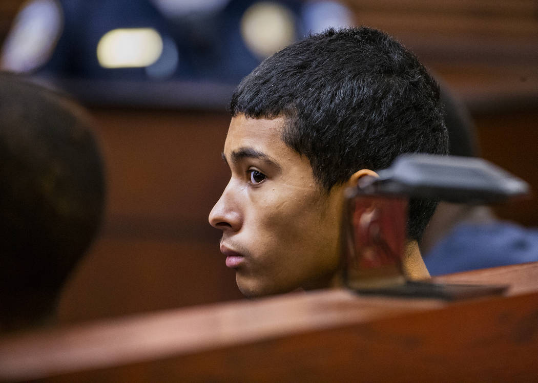 Defendant Josue Turcios waits before the judge with other defendants while appearing in Henders ...