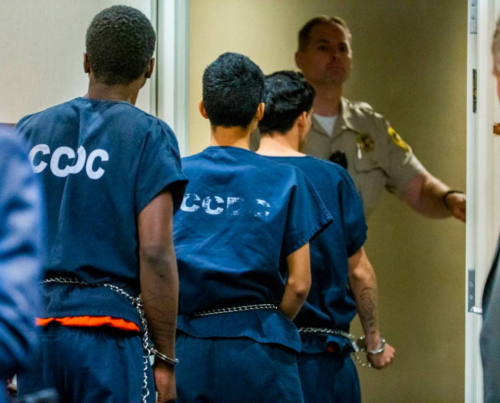 Defendants Tahj Simeus, Josue Turcios and Joseph DeFrancisco leave the courtroom after standing ...