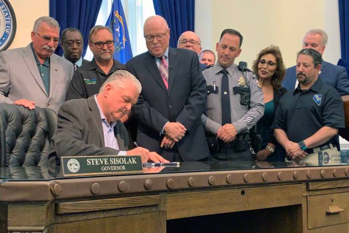 Nevada Gov. Steve Sisolak signs a number of bills in Carson City, Wednesday, June 12, 2019, inc ...