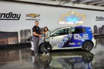 Findlay Chevrolet General Manager Doug Fleming congratulates Clark High School graduate Angela ...