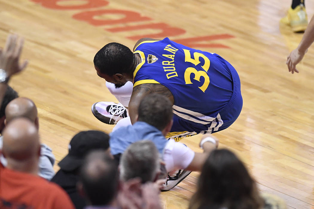 Golden State Warriors forward Kevin Durant (35) goes down with a leg injury against the Toronto ...