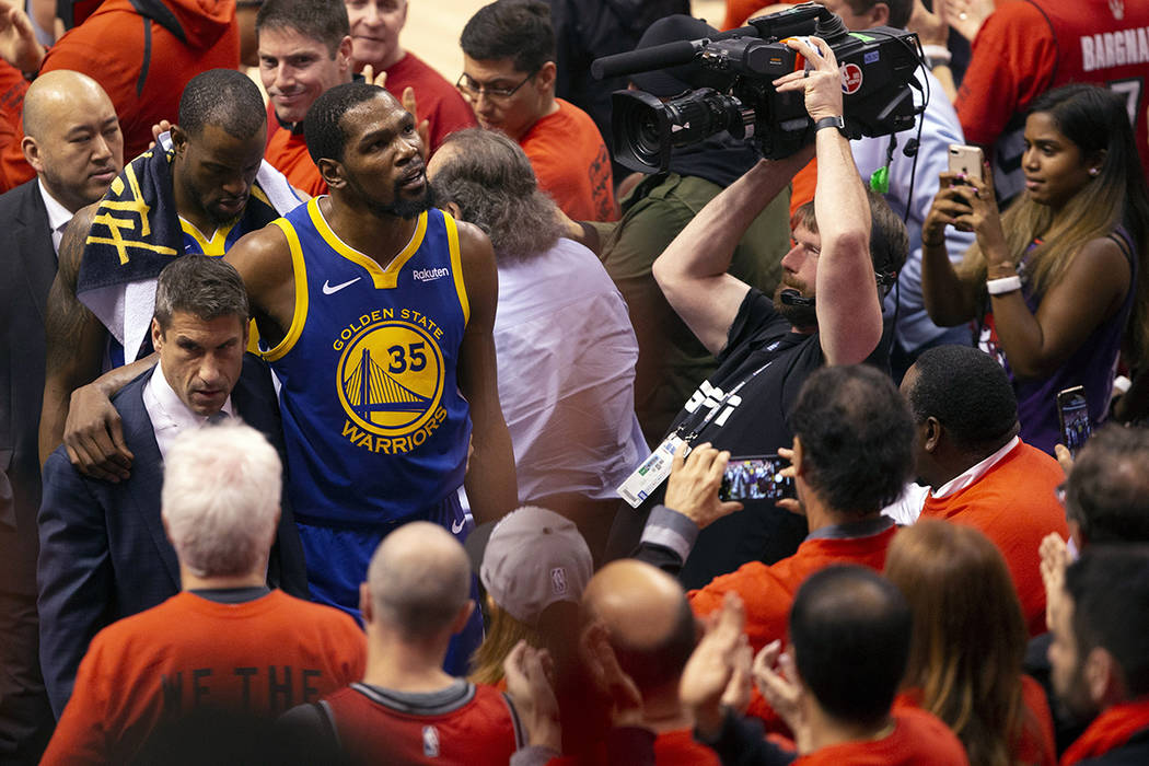 Golden State Warriors forward Kevin Durant glances up at the stands as he walks off the court a ...