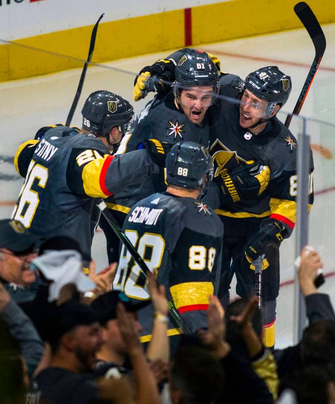 Golden Knights players celebrate the "hat trick" by their right wing Mark Stone (61) ...