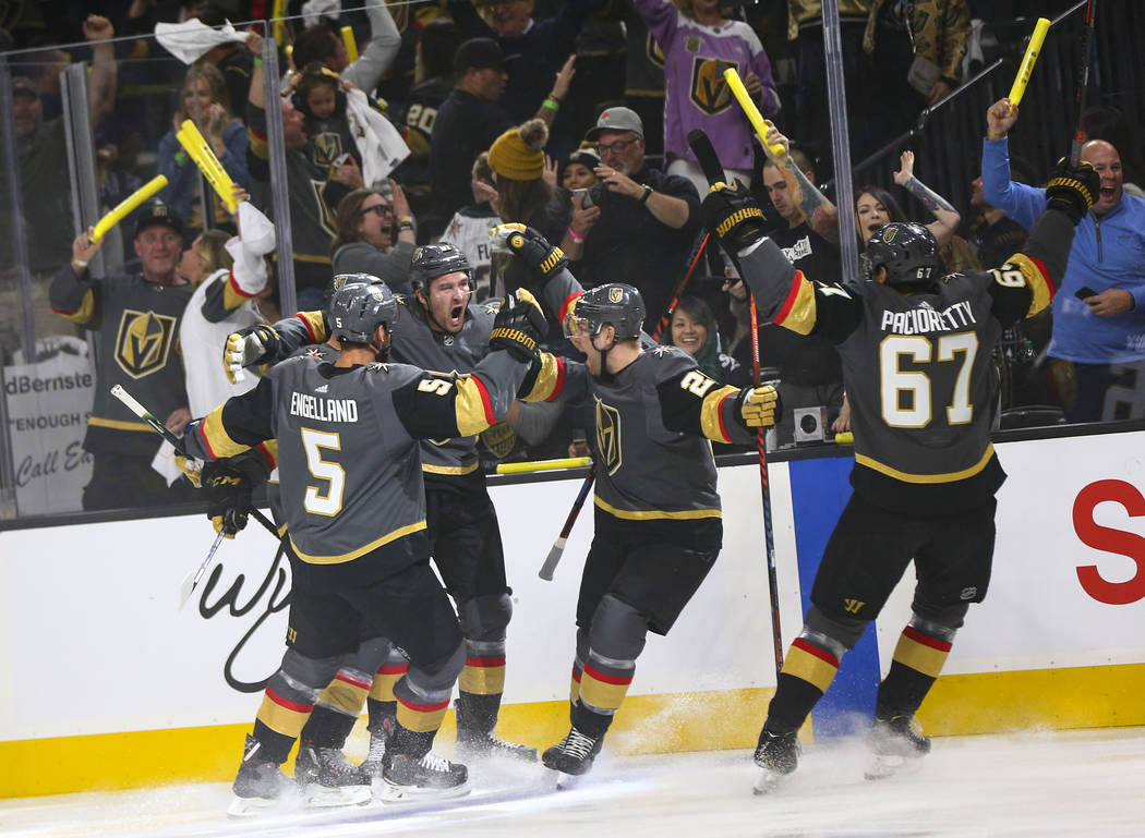 Golden Knights right wing Mark Stone, second from left, celebrates his goal with teammates Dery ...