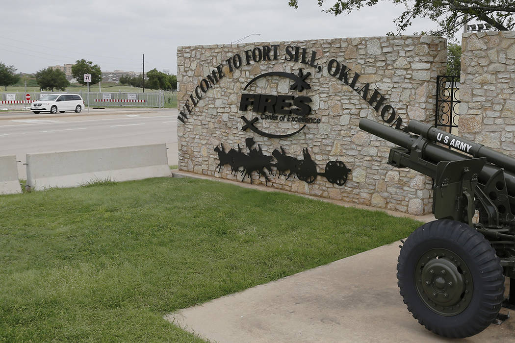 FILE - In this June 17, 2014 file photo, a vehicle drives by a sign at Scott Gate, one of the e ...