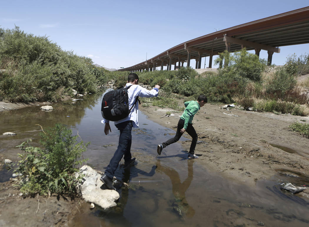 FILE - In this June 7, 2019 file photo, people cross the Rio Grande into the United States to t ...