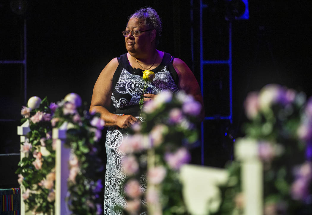 Organizer Dee Harris holds a rose during a Bridge of Peace Reconciliation Ceremony by the Women ...