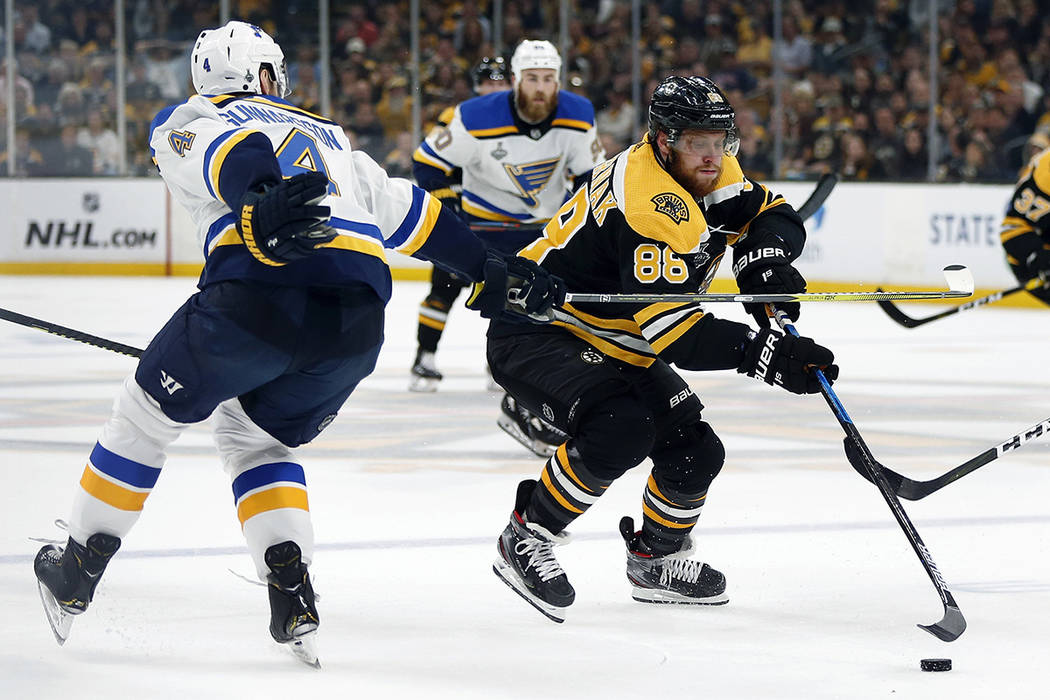 St. Louis Blues' Carl Gunnarsson, left, of Sweden, defends against Boston Bruins' David Pastrna ...