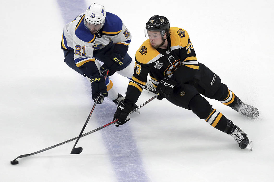 St. Louis Blues' Tyler Bozak, left, defends against Boston Bruins' Charlie McAvoy during the se ...