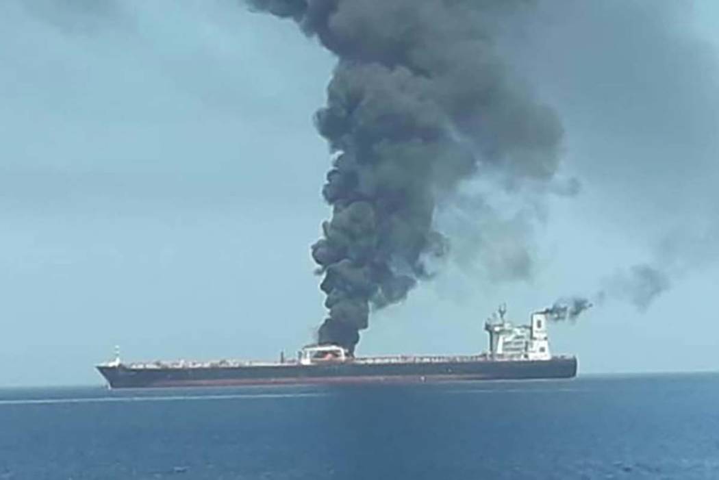 A plume of smoke rises from the MT Front Altair after the ship was attacked in the Strait of Ho ...