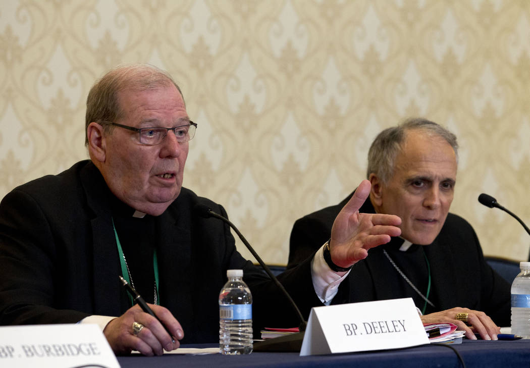 Robert Deeley, left, Bishop of the Diocese of Portland, accompanied by Cardinal Daniel DiNardo, ...