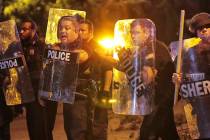 Memphis police brace against the crowd as protesters take to the streets of the Frayser communi ...