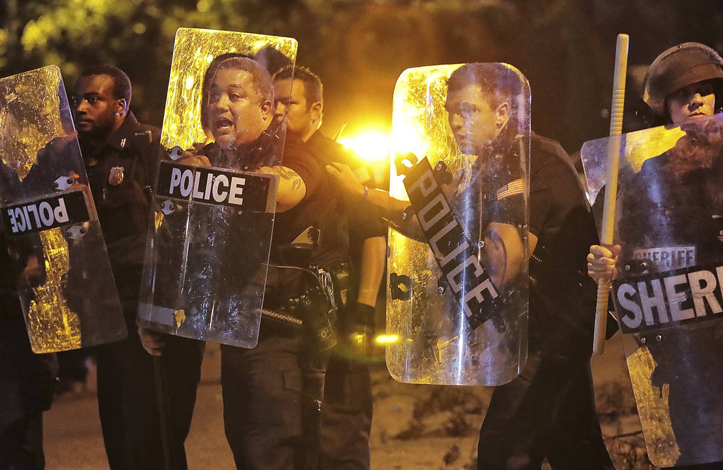 Memphis police brace against the crowd as protesters take to the streets of the Frayser communi ...